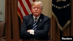 U.S. President Donald Trump waits for reporters to leave the room after speaking about his summit with Russia's President Putin during a meeting with members of the U.S. Congress at the White House in Washington, July 17, 2018. 
