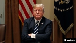 U.S. President Donald Trump waits for reporters to leave the room after speaking about his summit with Russia's President Putin during a meeting with members of the U.S. Congress at the White House in Washington, July 17, 2018. 