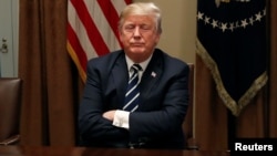 U.S. President Donald Trump waits for reporters to leave the room after speaking about his summit with Russia's President Putin during a meeting with members of the U.S. Congress at the White House in Washington, July 17, 2018. 