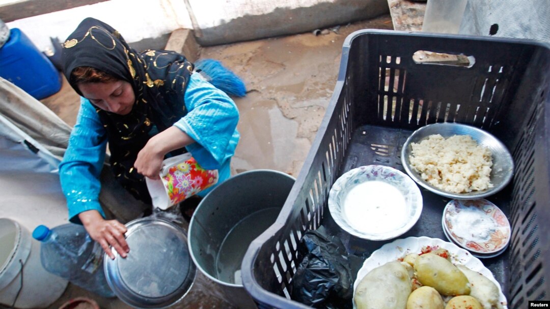 A Syrian refugee washes dishes at a camp in Tyre, Lebanon, Jan. 31, 2013. 