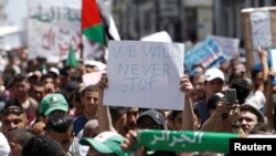 Students carry banners and flags during an anti-government protest in Algiers, Algeria, June 18, 2019. 