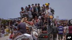 FILE—Palestinians fleeing from the southern Gaza city of Rafah during an Israeli ground and air offensive in the city on May 28, 2024. 