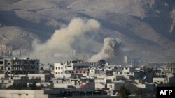 Smoke billows following Syrian government bombardments on the besieged rebel-held town of Hamouria in the eastern Ghouta region on the outskirts of the capital Damascus, March 3, 2018.