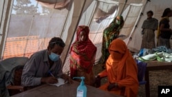Tigray refugees who fled a conflict in the Ethiopia's Tigray region, receive treatment at a clinic run by MSF in Village 8, the transit center near the Lugdi border crossing, eastern Sudan, Dec. 8, 2020.
