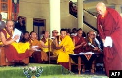 FILE - Tibetan spiritual leader Dalai Lama (L) greets Prime Minister of the Tibetan government-in-exile Samdong Rinpoche (R) during celebrations of the 360th anniversary of the creation of the Tibetan government, in Dharamsala, India, June, 5, 2002.