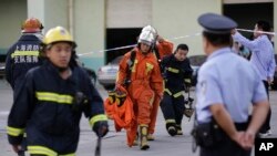 Firefighters walk out from the main gate of Weng's Cold Storage Industrial Co. Ltd. at the outskirts of Shanghai, China, Aug. 31, 2013.