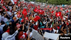 Supporters of Tunisian President Kais Saied rally in support of his seizure of power and suspension of parliament, in Tunis, Oct. 3, 2021.