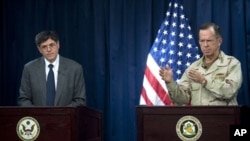 Navy Adm. Mike Mullen, chairman of the Joint Chiefs of Staff, and Deputy Secretary of State Jacob Lew address the media at the Combined Press Information Center in Baghdad, Iraq, 27 Jul 2010