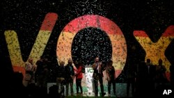 Santiago Abascal, the national president of VOX, center, applauds during a rally of the fledging far-right party VOX in Madrid, Oct. 7, 2018.