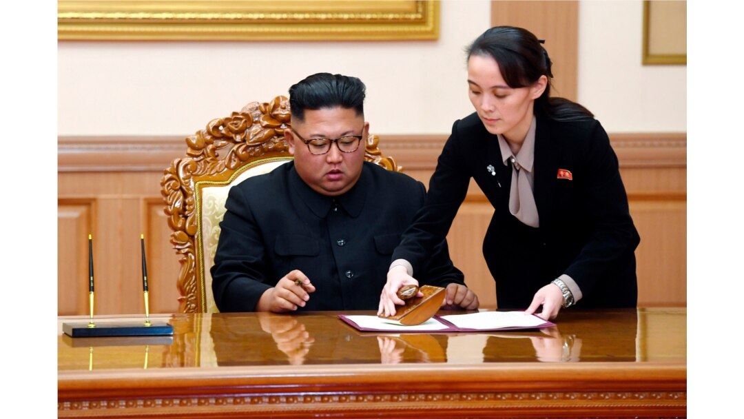 FILE - Kim Yo Jong, right, sister of North Korean leader Kim Jong Un, helps Kim sign joint statement following the summit with South Korean President Moon Jae-in at the Paekhwawon State Guesthouse in Pyongyang.