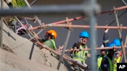 Rescue workers search the site of a building collapse in George, South Africa, Wednesday, May 8, 2024. 