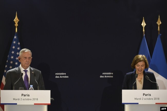 FILE - French Defense Minister Florence Parly speaks next to US Defense Secretary Jim Mattis during a press conference after their meeting at the French Defense ministry in Paris, Oct. 2, 2018.