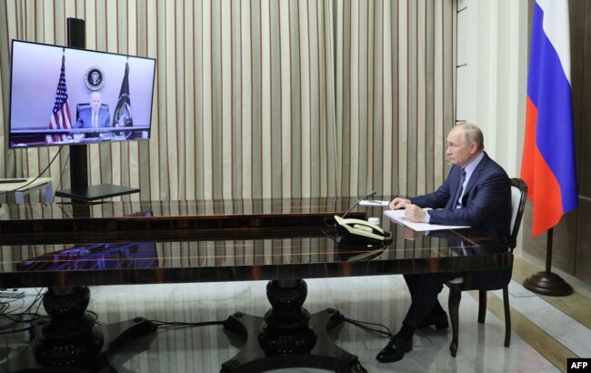 Russian President Vladimir Putin attends a meeting with US President Joe Biden via a video call in the Black Sea resort of Sochi on December 7, 2021. (Photo by Mikhail Metzel / SPUTNIK)