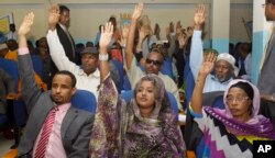 FILE - Somalia lawmakers raise their hands during a confidence vote on Prime Minister Abdiweli Sheikh Ahmed, at the Parliament Building in Mogadishu, Somalia, Dec. 6, 2014.