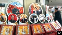 A Chinese man walks past ceramic plates with images of Chinese President Xi Jinping displayed at a rest stop near Beijing, Dec. 30, 2016. During his New Year Eve's speech, Xi said his government would resolutely defend China's territorial rights.