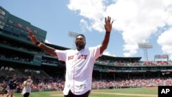 Former Boston Red Sox's David Ortiz waves to the crowd during ceremonies to honor the Red Sox 2007 World Series winning baseball teamm Sunday, July 30, 2017, in Boston. (AP Photo/Steven Senne)