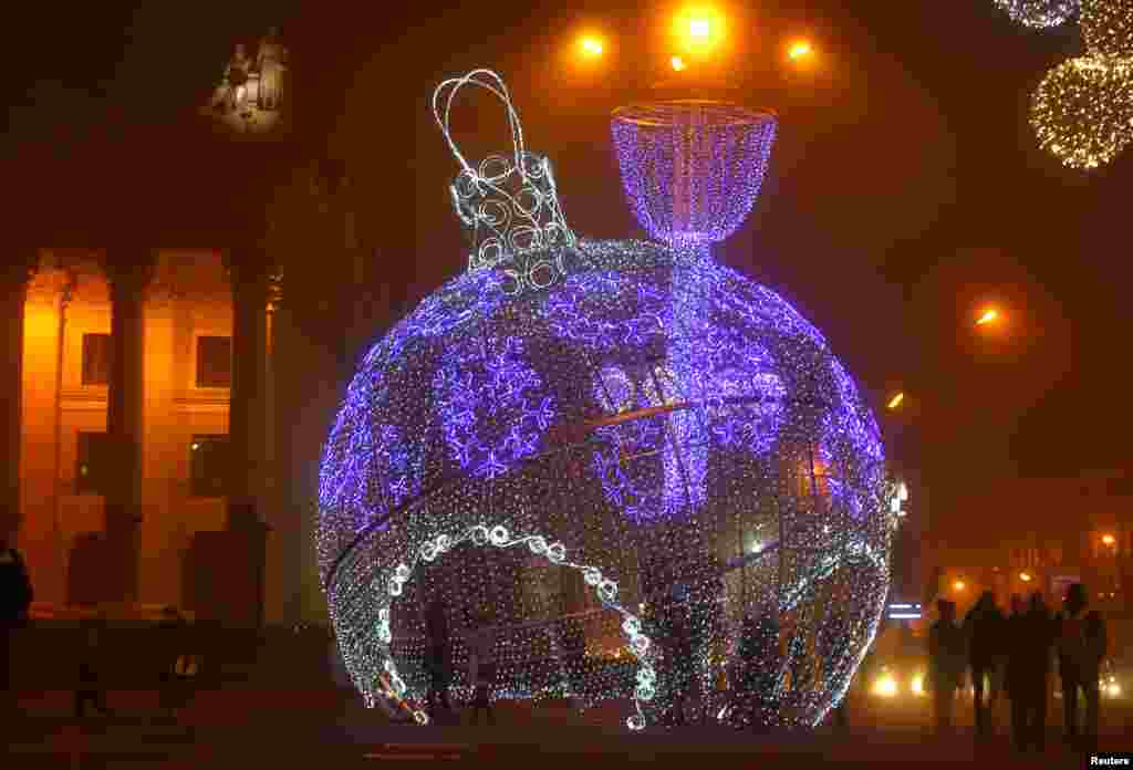 A giant illuminated Christmas ball is seen on Oktyabrskaya Square for the upcoming New Year and Christmas season in Minsk, Belarus.