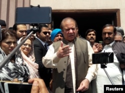 FILE - Pakistan's former Prime Minister Nawaz Sharif talks to media after appearing before the accountability court to face the corruption references filed against him, in Islamabad, Pakistan, April 17, 2018.
