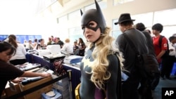 Jessica Chancellor, dressed as Batgirl, waits in line for her credential on Preview Night at Comic-Con International at the San Diego Convention Center, July 20, 2016.