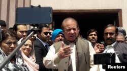 FILE - Pakistan's former Prime Minister Nawaz Sharif talks to media after appearing before the accountability court to face the corruption references filed against him, in Islamabad, Pakistan, April 17, 2018. 