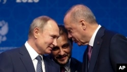 In this Jan. 8, 2020 file photo, Turkey's President Recep Tayyip Erdogan, right and Russia's President Vladimir Putin talk during a ceremony in Istanbul for the inauguration of the TurkStream pipeline.