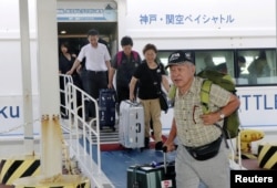 Passengers who were stranded at Kansai International Airport due to powerful typhoon Jebi are transported out by a high-speed boat at Kobe airport, in Kobe, Japan, in this photo taken by Kyodo, Sept. 5, 2018. (Kyodo/via Reuters)