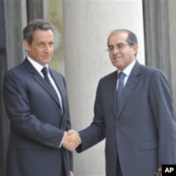 France's President Nicolas Sarkozy, left, greets the head of Libya's opposition government Mahmoud Jibril at the Elysee Palace in Paris, August 24, 2011.