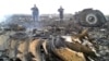 Ukrainian Emergencies Ministry personnel work at the site of the Malaysia Airlines Boeing 777 crash near the village of Grabovo in the Donetsk region, July 17, 2014.