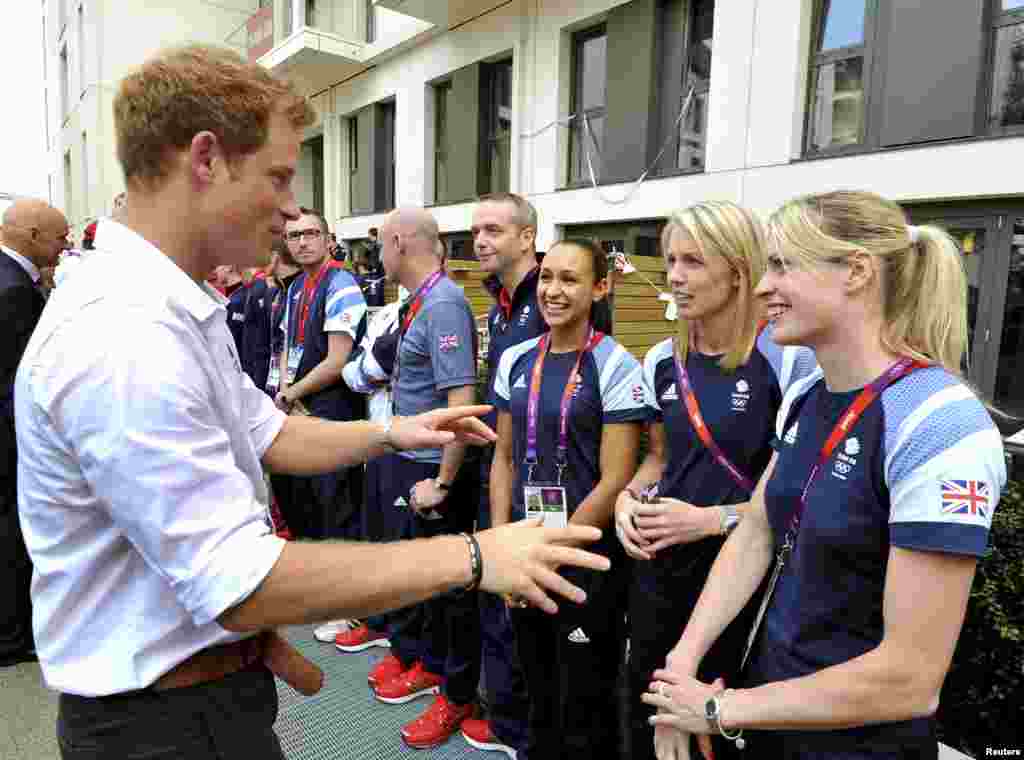 Britain's Prince Harry talks with athletes including British runner Jessica Ennis (3rd R), during a visit to the accommodation for British athletes in the Athletes Village at Olympic Park in Stratford, east London July 31, 2012.