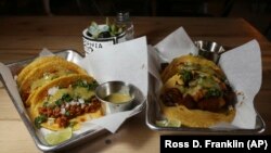 In this Friday, October 18, 2019 photo is two of the taco selections at the Earth Plant Based Cuisine restaurant in Phoenix.