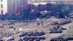 FILE - Chinese troops and tanks gather in Beijing, one day after the military crackdown that ended a seven week pro-democracy demonstration on Tiananmen Square, June 5, 1989.
