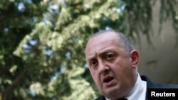 FILE - Georgia's President Georgy Margvelashvili speaks to the media after leaving the residence of the late Georgia's former president and Soviet foreign minister Eduard Shevardnadze, in Tbilisi July 7, 2014.