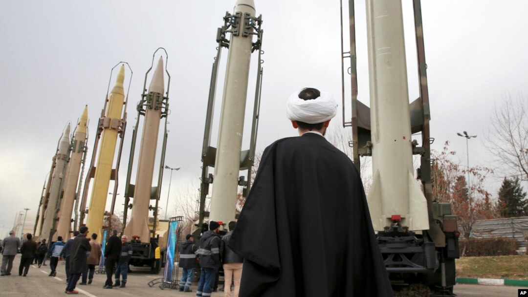 An Iranian cleric looks at domestically built surface-to-surface missiles at a military show marking the 40th anniversary of Iran's Islamic Revolution that toppled the U.S.-backed shah, at Imam Khomeini Grand Mosque, in Tehran, Iran, Feb. 3, 2019. 