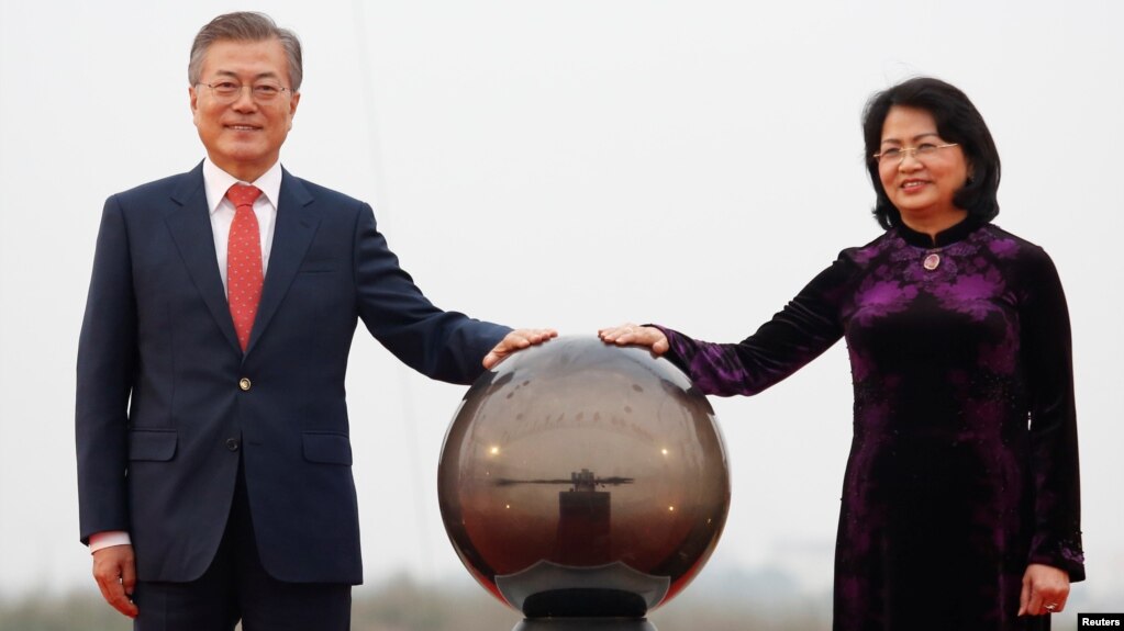 FILE - South Korea's President Moon Jae-in, left, and Vietnam's Vice President Dang Thi Ngoc Thinh attend the breaking ceremony of the Vietnam Korea Institute of Science and Technology at Hoa Lac Hi-Tech Park in Hanoi, Vietnam, March 22, 2018. Vietnam appointed Ngoc Thinh acting president Sunday.