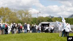 Unionists queue for a quick meal before a demonstration as French legislators are starting to debate a hotly contested labor bill that would make it easier to lay off workers and weaken some union powers, May 3, 2016 in Paris. 