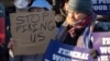 Demonstrators rally in support of federal workers outside of the Department of Health and Human Services in Washington, Feb. 14, 2025.