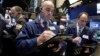 Fred DeMarco, center, works with fellow traders on the floor of the New York Stock Exchange, Nov. 2, 2016. The S&P 500 closed lower by a fraction of a percent on Friday, Nov. 4, for the ninth trading session in a row. 