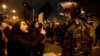 Una mujer asistente a la vigilia por los muertos en derribo de avión ucraniano en Irán habla con un policía en Teherán el 11 de enero de 2020.