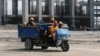 FILE - Workers ride in a vehicle at the construction site of the Dangote oil refinery in Ibeju Lekki district, on the outskirts of Lagos, Nigeria, Aug. 7, 2019. 