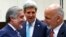 With U.S. Secretary of State John Kerry (C) watching, Afghanistan President Mohammad Ashraf Ghani (R) talks with Afghan Chief Executive Abdullah Abdullah at a NATO foreign ministers meeting in Brussels, Dec. 2, 2014.