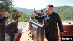 FILE - North Korean Leader Kim Jong Un reacts during the test-firing of an intercontinental ballistic missile in a photo released by North Korea's Korean Central News Agency (KCNA), in Pyongyang, July, 4 2017.