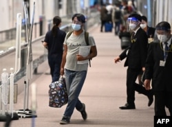 FILE - Japanese journalist Yuki Kitazumi, who was arrested by security forces while covering the aftermath of the Myanmar coup, arrives at Narita Airport in Narita, Chiba prefecture on May 14, 2021, after charges against him were dropped.
