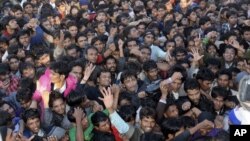 Indian cricket fans jostle for tickets for the second Twenty20 cricket match between India and Pakistan in Ahmadabad, India, December 26, 2012. 