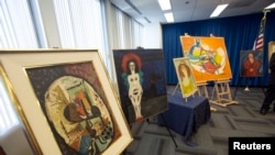 FILE - Recovered paintings are pictured during a news conference at FBI Headquarters in Los Angeles, California, Dec. 19, 2014. 