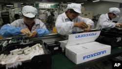 FILE - An assembly line in a Foxconn plant.
