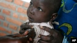 FILE - A child is immunized against measles at a clinic in eastern Congo, Nov. 13, 2008.