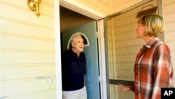 File - Carl Johnsen speaks with neighbor Heidi Lange in Paradise, California. A 2024 study found that 1 in 100 current residents move away if they get new neighbors with different political views.