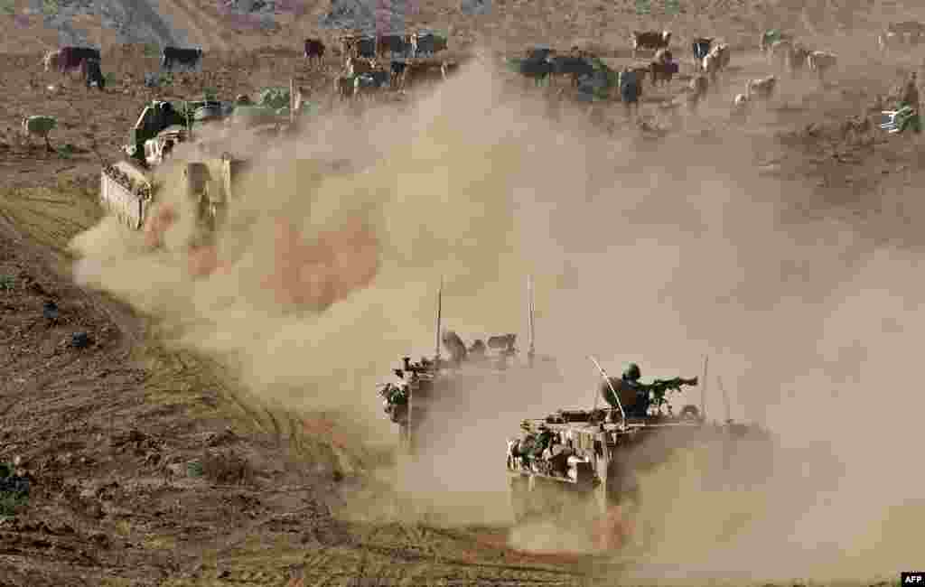 Israeli armored vehicles take part in a drill in the Israeli-annexed Golan Heights, near the border with Syria.