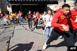 FILE - People flee after shots were fired near the Kansas City Chiefs' Super Bowl LVIII victory parade in Kansas City, Missouri, on Feb. 14, 2024.