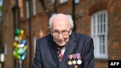 British World War II veteran Captain Tom Moore, 99, walks a lap of his garden in the village of Marston Moretaine, 50 miles north of London, April 16, 2020.